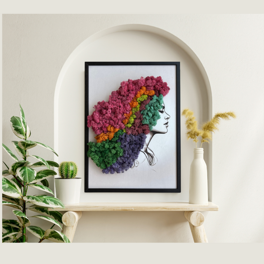 Framed artwork of a colorful hair design on a shelf with plants