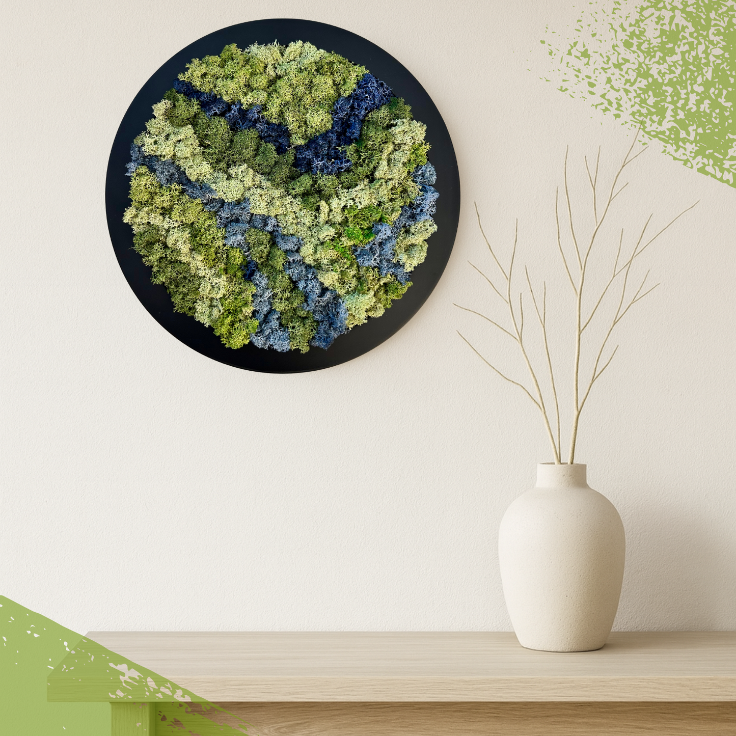 Moss wall art on a white wall with a vase on a shelf below.